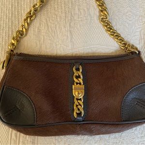 Juicy Couture 9”x2”x4”. Heavy chain strap.Cowhide and leather.Brown in color.